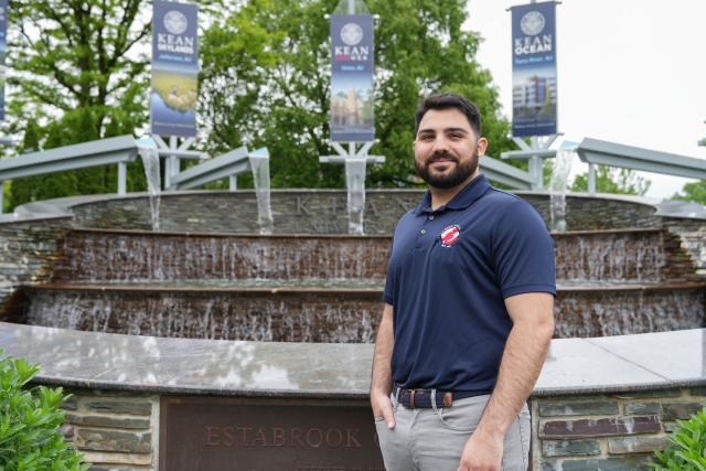 Frank Capone is photographed in front of the fountain at Kean.